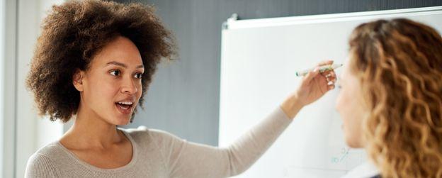 A person at the whiteboard explaining something